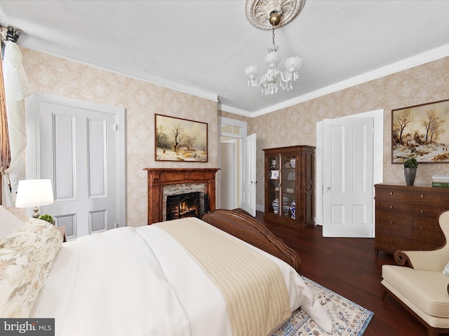 bedroom featuring an inviting chandelier, ornamental molding, and dark wood-type flooring