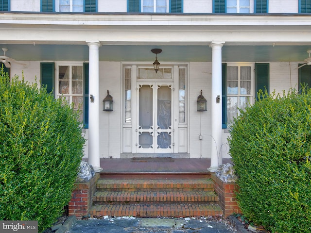 view of exterior entry with covered porch