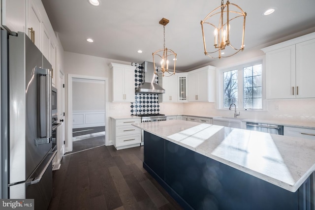 kitchen with backsplash, stainless steel appliances, white cabinets, wall chimney exhaust hood, and dark hardwood / wood-style flooring