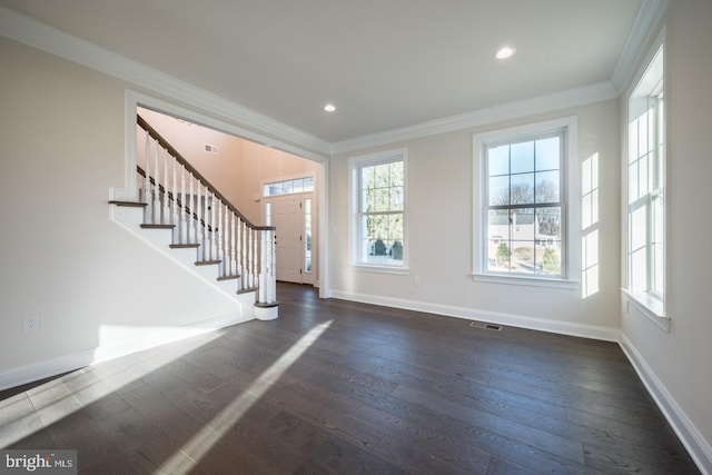 foyer with crown molding, dark hardwood / wood-style flooring, and a wealth of natural light