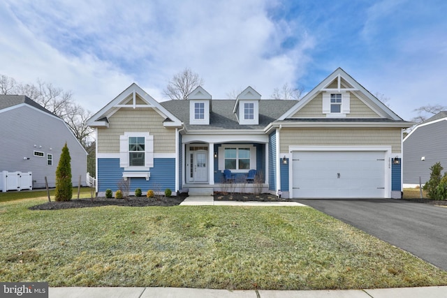 view of front of house featuring a front lawn, a porch, and a garage