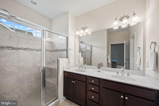 bathroom featuring walk in shower and double vanity