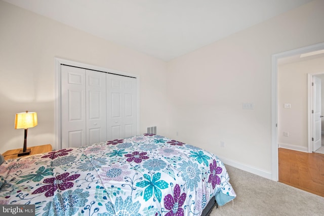 bedroom featuring a closet and light carpet