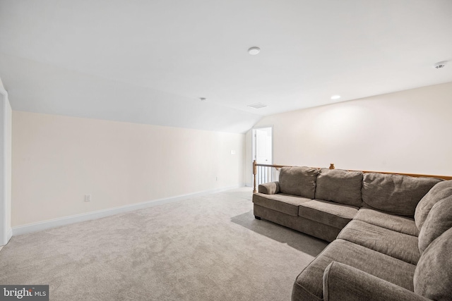 carpeted living room featuring vaulted ceiling