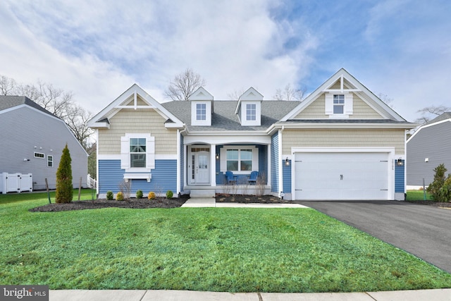 view of front of property featuring a front yard and a garage