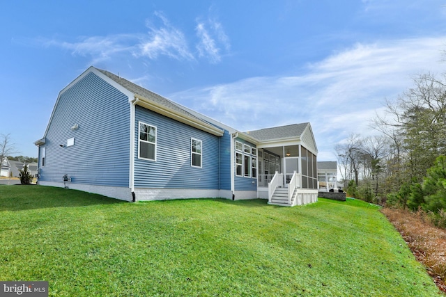 back of house with a sunroom and a yard