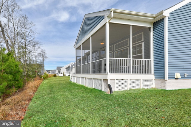 view of property exterior featuring a sunroom and a lawn