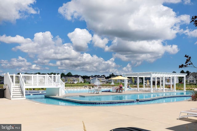 view of swimming pool with a pergola and a patio