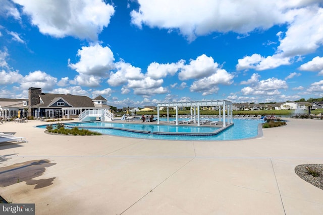 view of swimming pool with a pergola and a patio