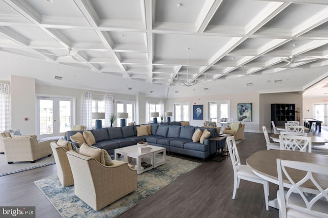 living room featuring a healthy amount of sunlight, coffered ceiling, dark wood-type flooring, and french doors