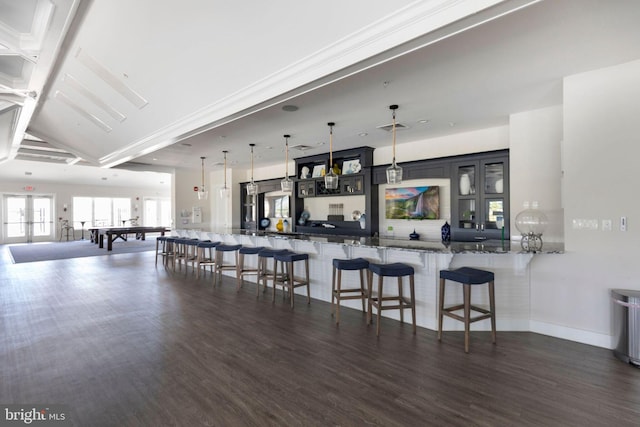 kitchen with coffered ceiling, a kitchen breakfast bar, dark wood-type flooring, and french doors