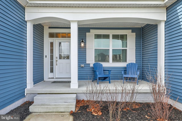 view of exterior entry with a porch