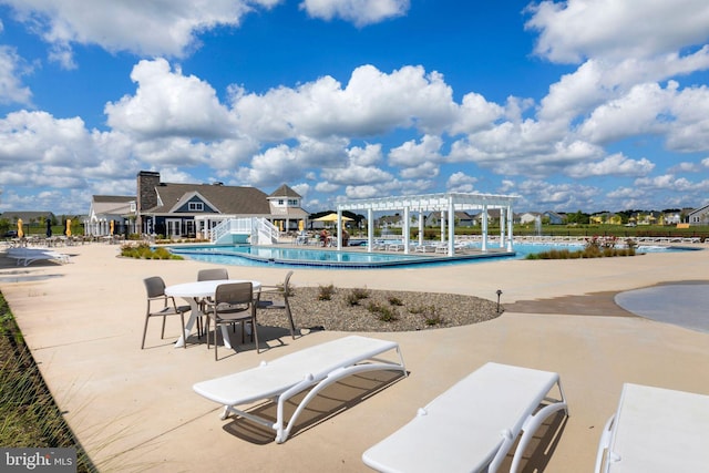 view of swimming pool featuring a pergola and a patio area