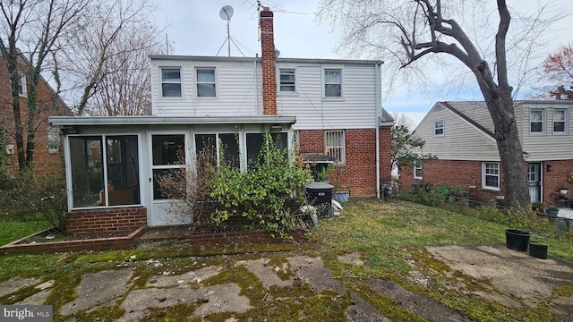 rear view of house featuring a sunroom