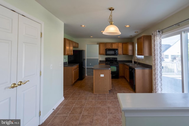 kitchen with a center island, pendant lighting, tile floors, black appliances, and sink