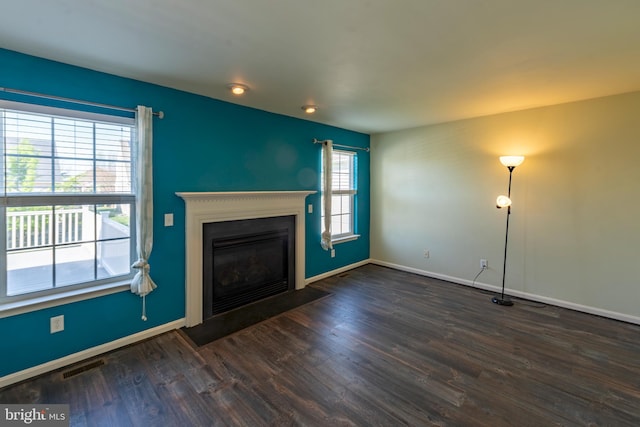 unfurnished living room featuring dark hardwood / wood-style flooring