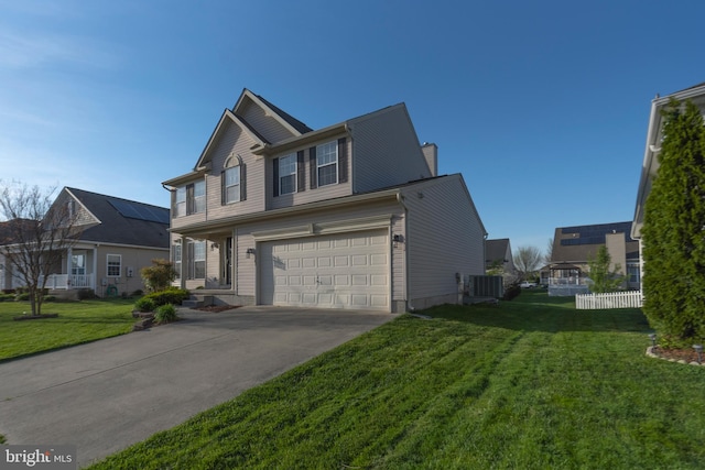 view of front facade featuring solar panels, a garage, a front yard, and central AC