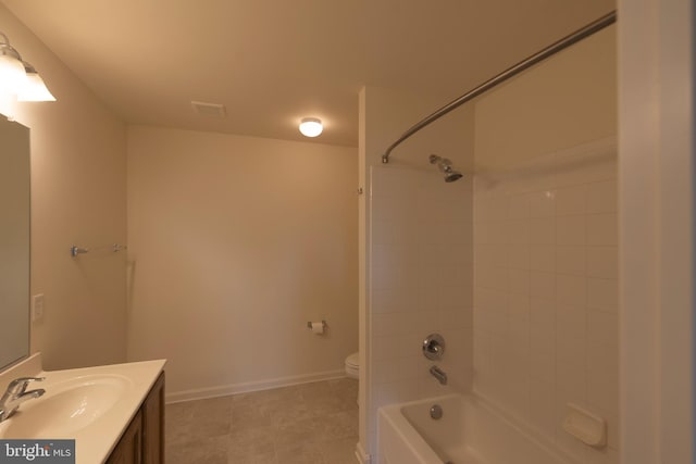 full bathroom featuring tiled shower / bath, toilet, oversized vanity, and tile flooring