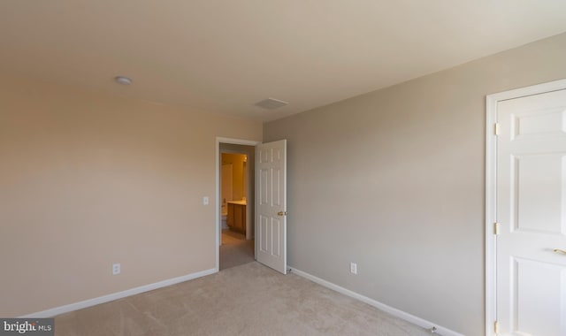 unfurnished bedroom featuring light colored carpet