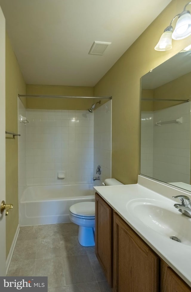 full bathroom featuring tile flooring, tiled shower / bath, vanity, and toilet