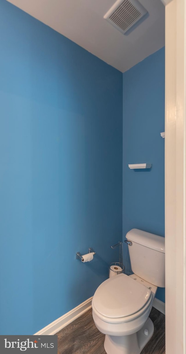 bathroom with wood-type flooring and toilet