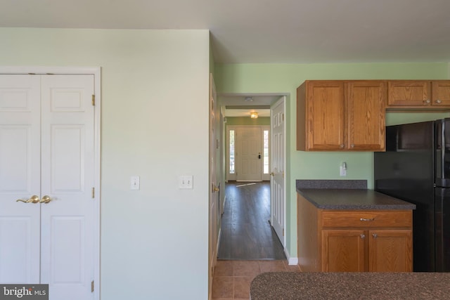 kitchen with black refrigerator and dark hardwood / wood-style floors