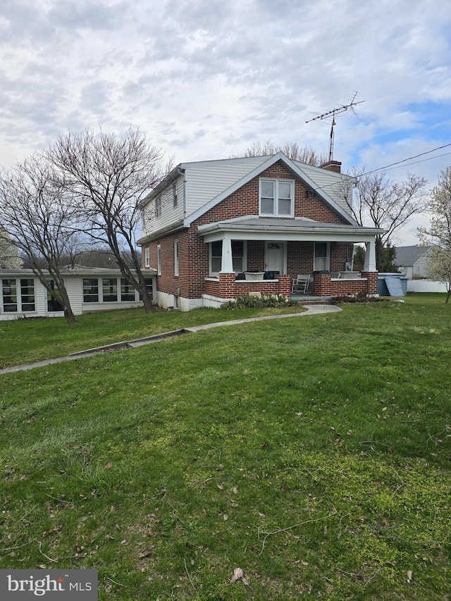 view of front facade with a porch and a front lawn