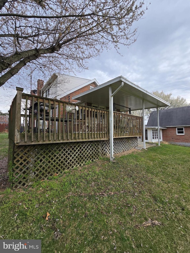 back of house featuring a yard and a wooden deck