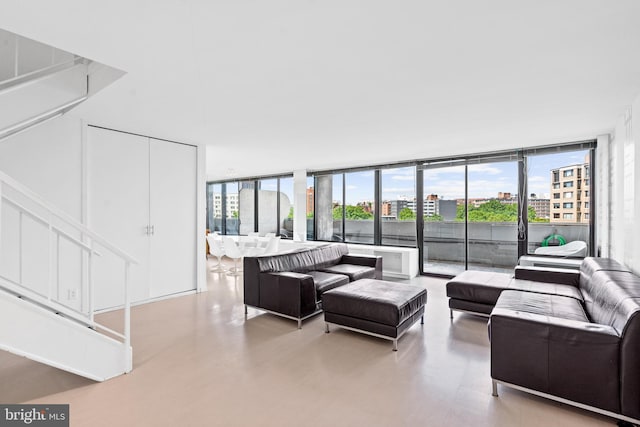 living room with expansive windows and light hardwood / wood-style flooring