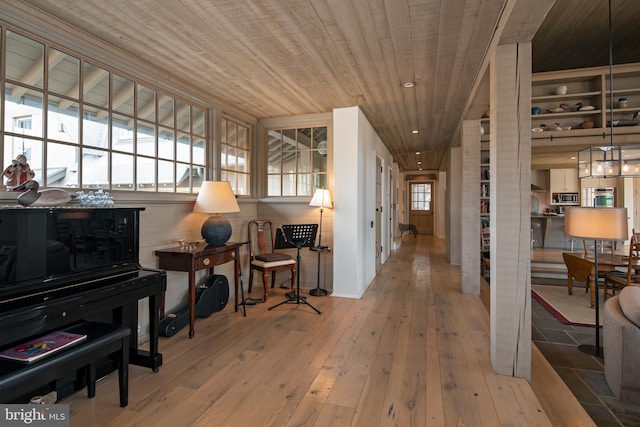 hall featuring wooden ceiling, a healthy amount of sunlight, and light hardwood / wood-style flooring