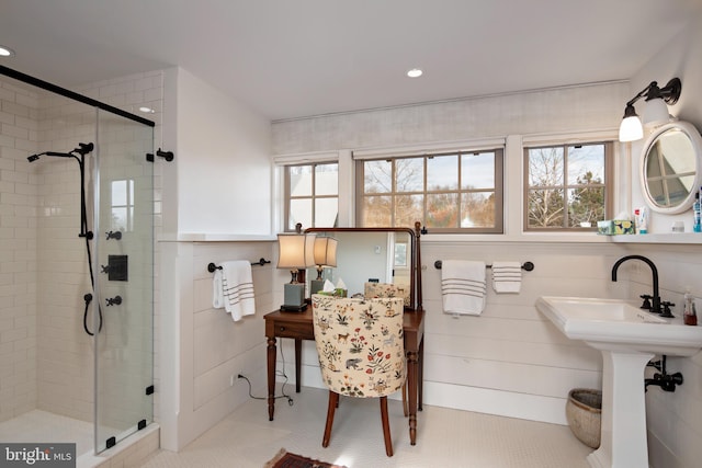 bathroom featuring a shower with door