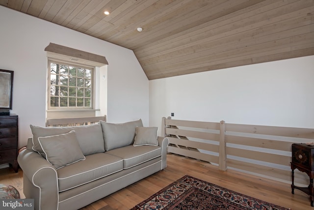 living room with lofted ceiling, wooden ceiling, and light hardwood / wood-style floors