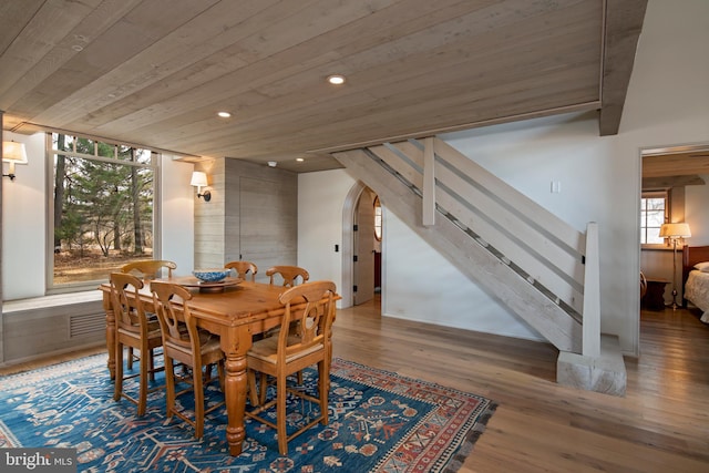 dining space featuring dark hardwood / wood-style floors and wooden ceiling