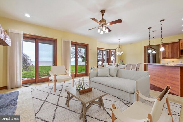 living room with ceiling fan and sink