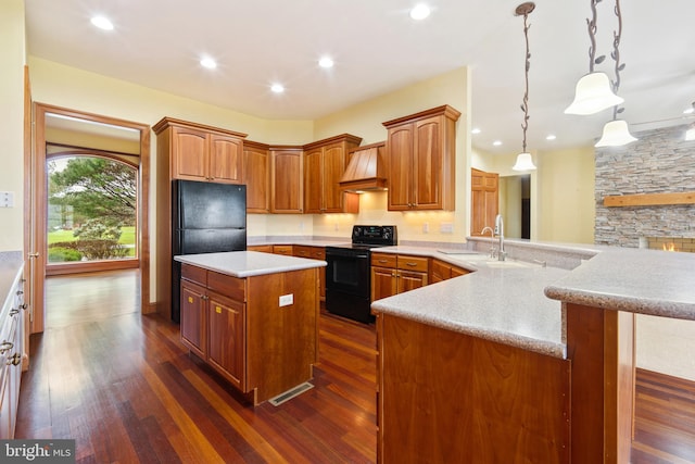 kitchen with dark wood-type flooring, black appliances, and custom exhaust hood