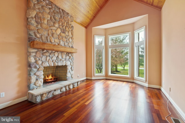 unfurnished living room featuring wood ceiling, high vaulted ceiling, dark wood-type flooring, and a fireplace
