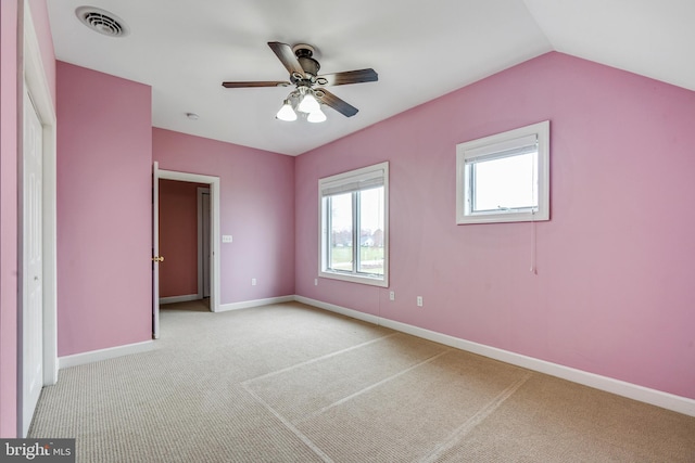carpeted spare room with ceiling fan and lofted ceiling