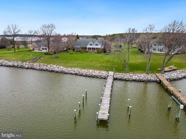 dock area featuring a water view and a lawn