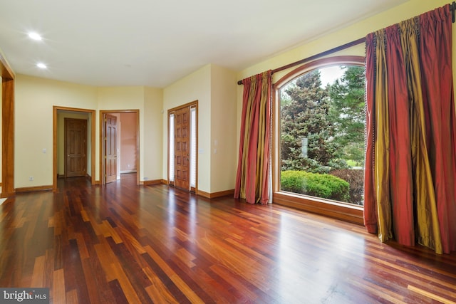 unfurnished room with dark hardwood / wood-style floors