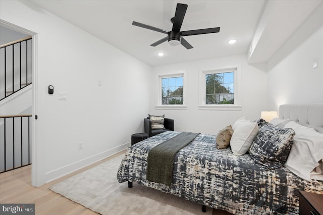 bedroom with light hardwood / wood-style floors and ceiling fan