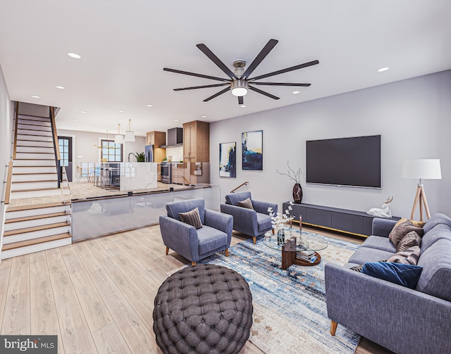 living room with ceiling fan and light hardwood / wood-style flooring