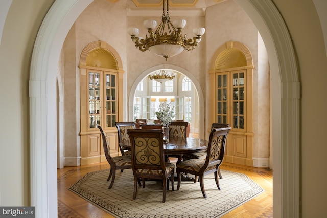 dining space featuring crown molding and a notable chandelier