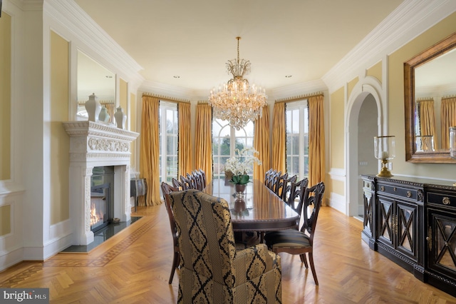 dining area featuring light parquet flooring, a notable chandelier, and ornamental molding