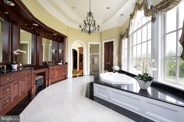 bathroom featuring a chandelier, vanity, a washtub, tile floors, and a raised ceiling