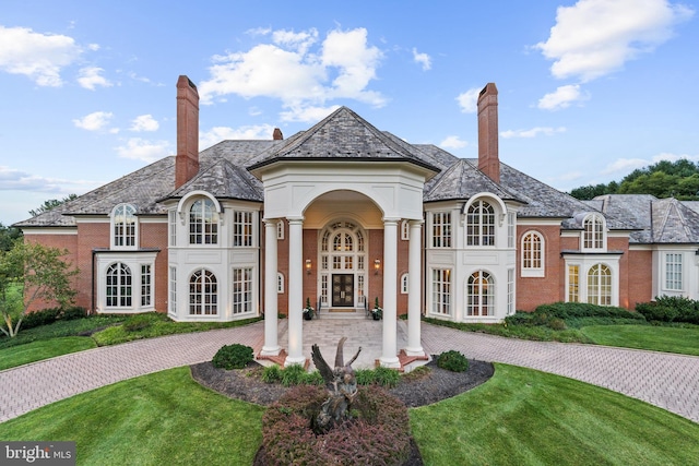 view of front of home with french doors and a front yard