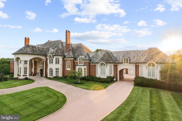 view of front of house with a front lawn and french doors