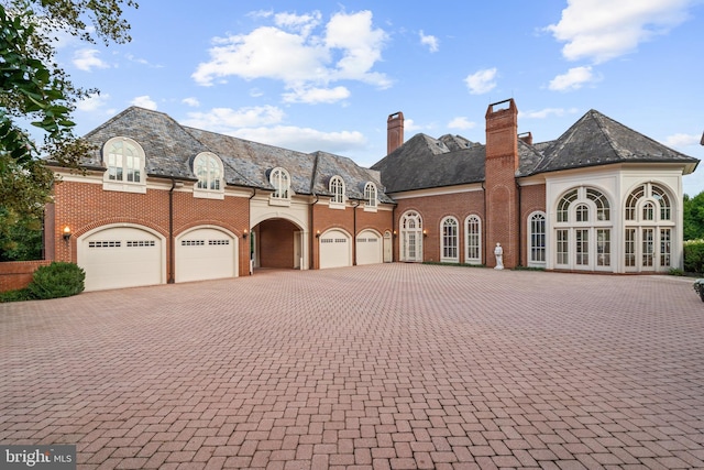 french country inspired facade with a garage