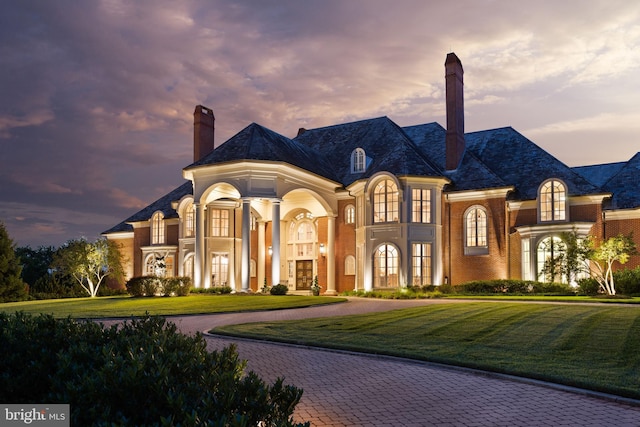 exterior space featuring a yard and french doors