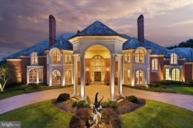 view of front facade featuring a yard and french doors