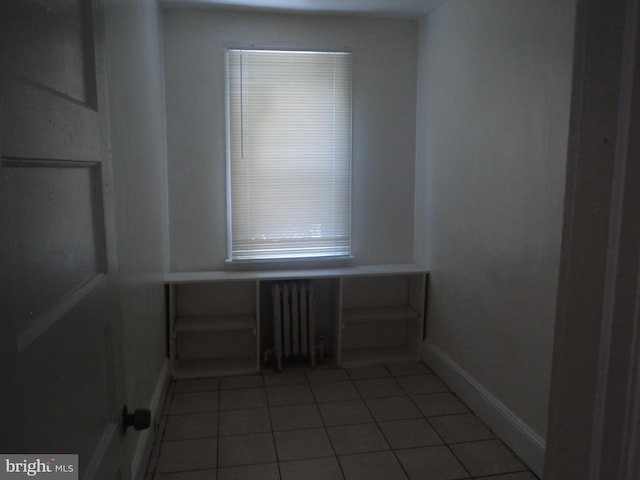 spare room with tile patterned floors and radiator heating unit